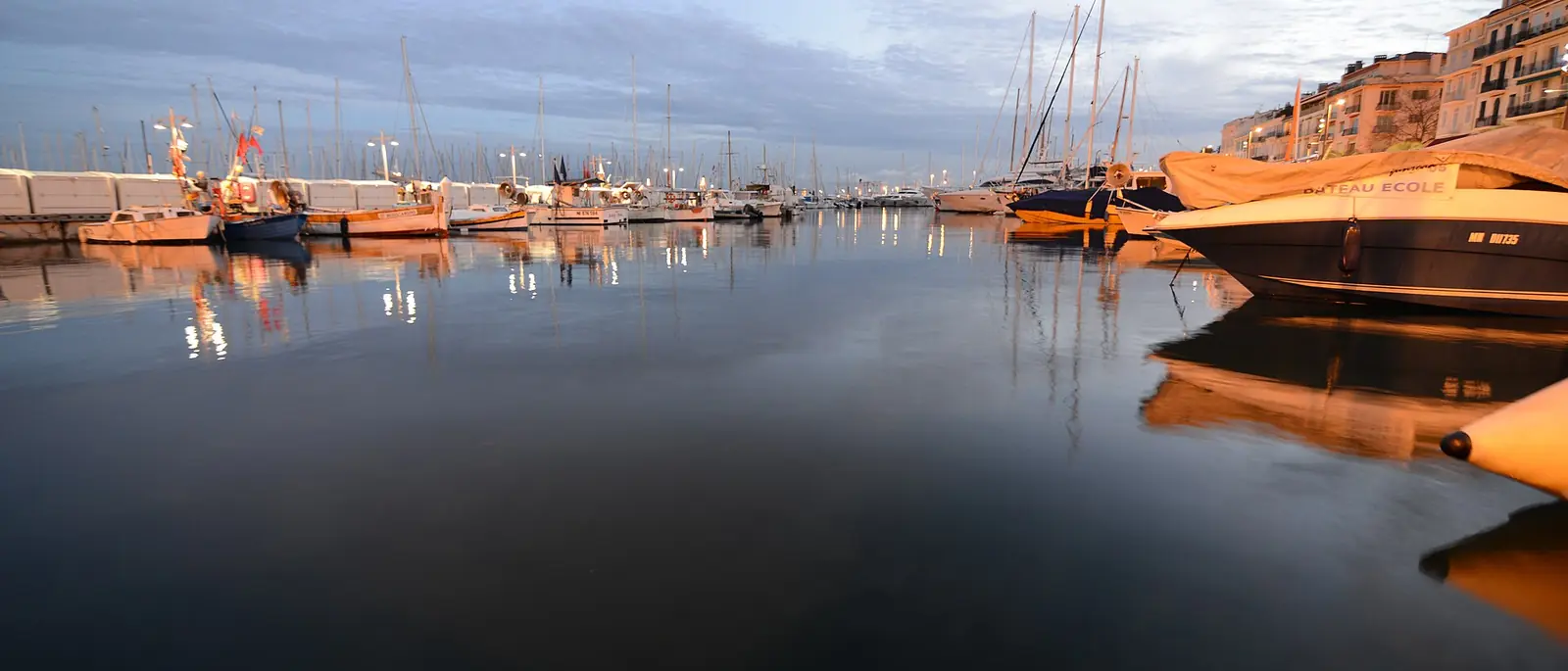 Yachts moored along the quay of a Vieux Port at first light